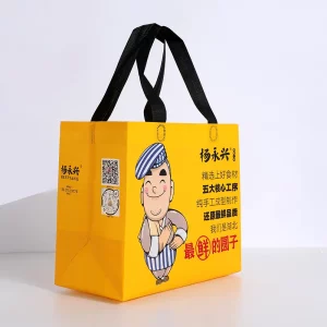Yellow laminated non-woven take-out bag with black handles for food delivery